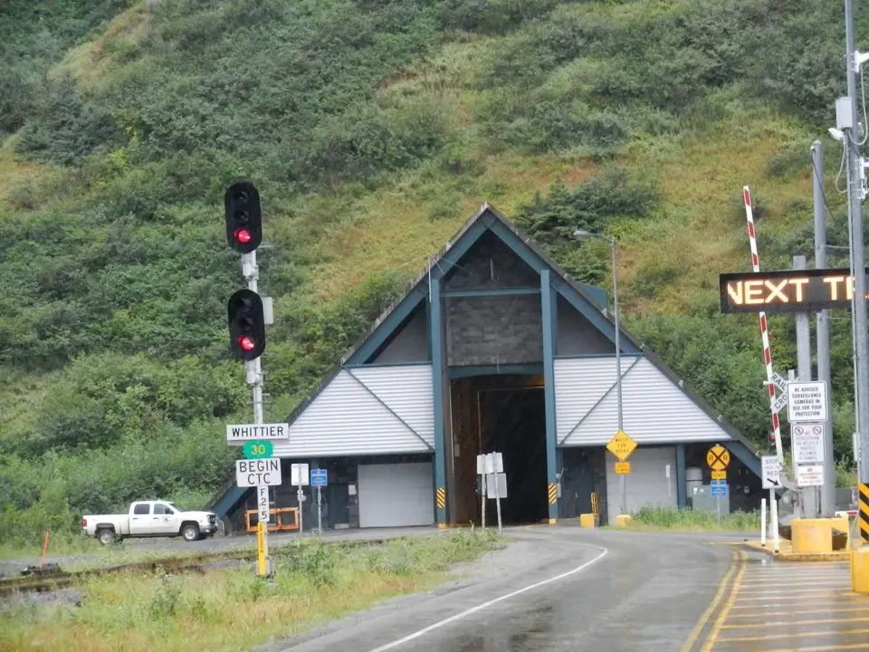 A train station in a hilly landscape.