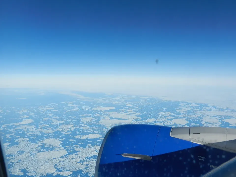 A view from above of the frozen sea under a clear sky.