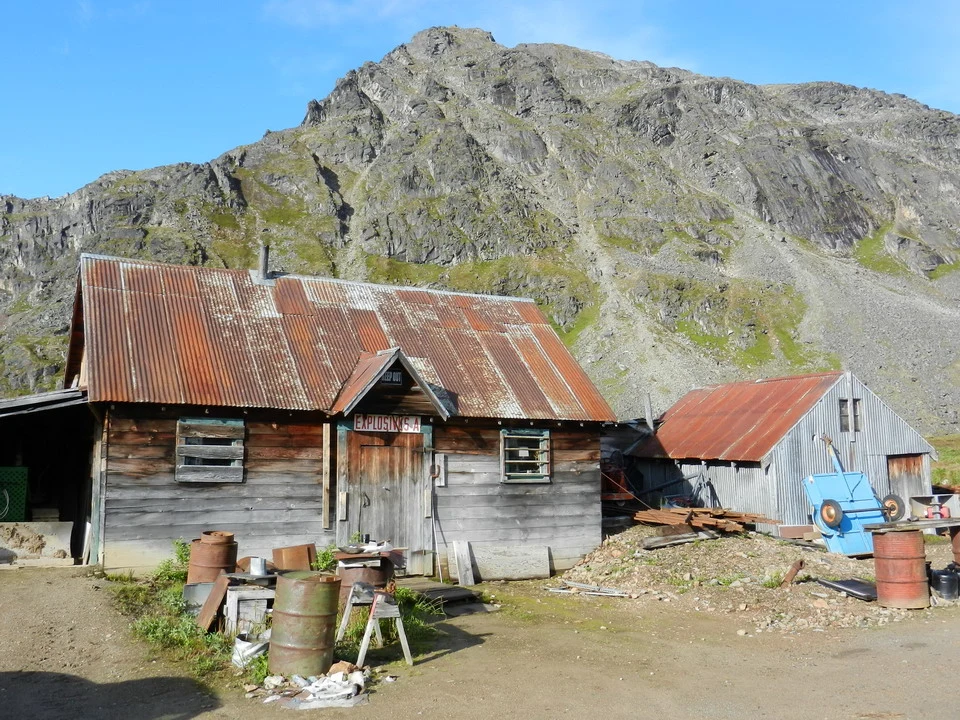 A mountain landscape with wooden buildings and tin roofs.