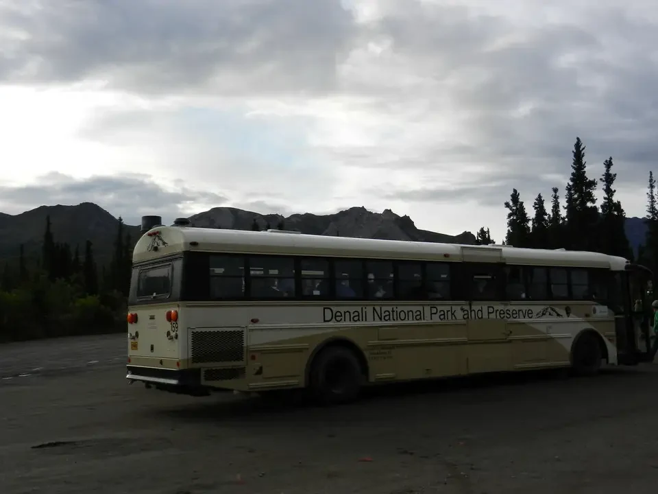 A bus travels through a mountain landscape.
