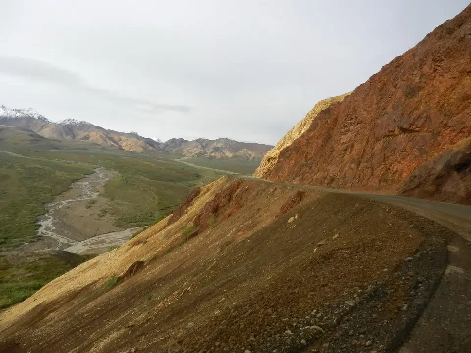 A mountain landscape with a river flowing through arid hills.