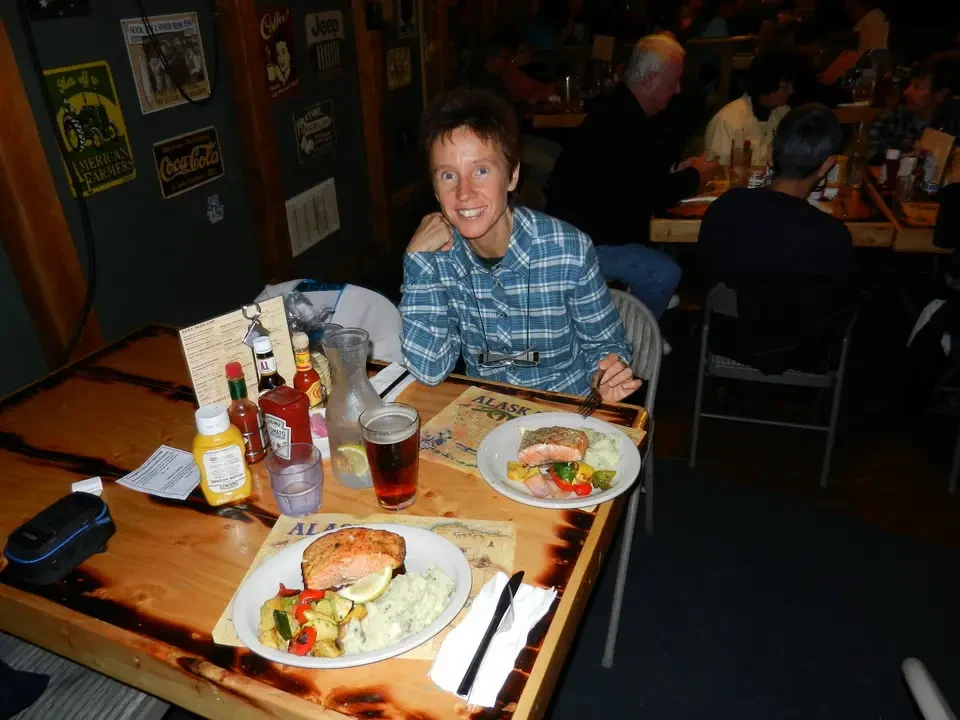 A group of people have lunch together at a table in a restaurant.