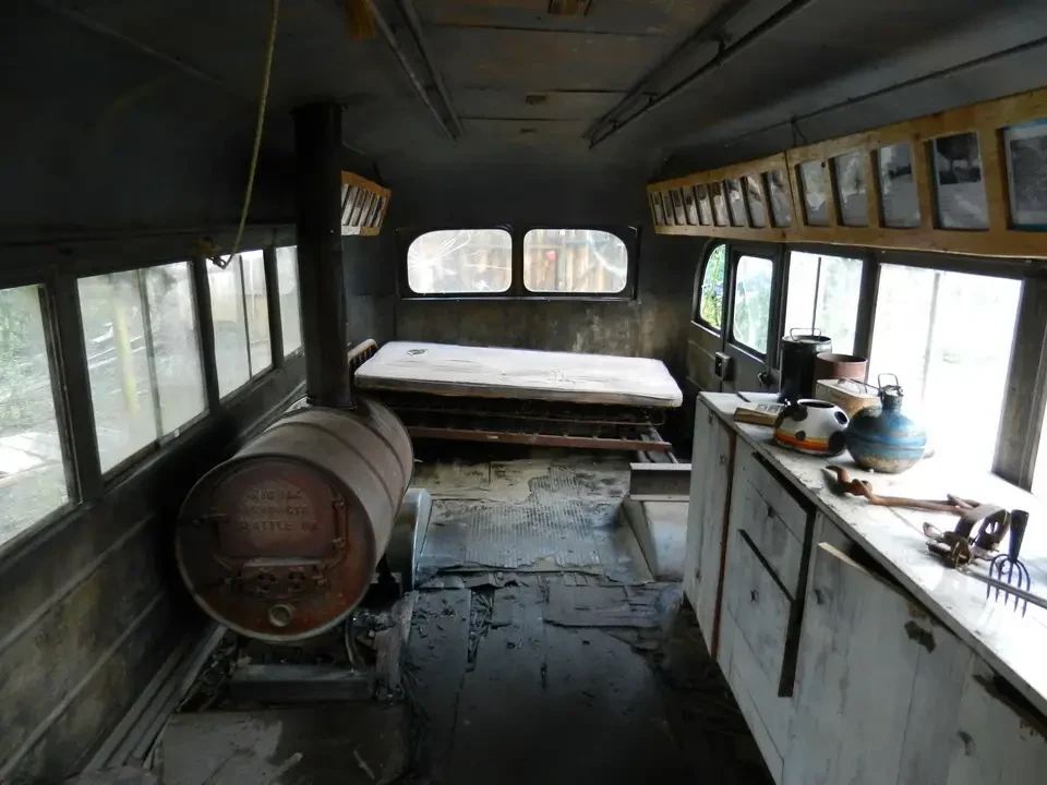 Interior of an old railway carriage with windows and equipment.