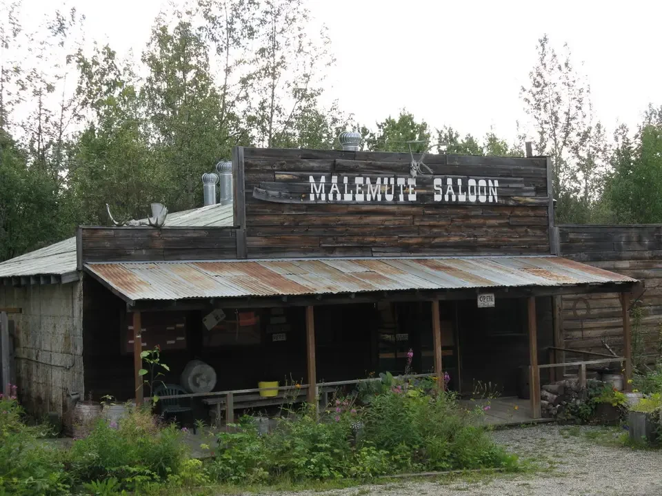 An old wooden inn with the words 'MALE MUTE SALOON' in the foreground.