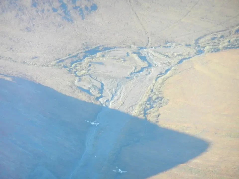A narrow, rocky valley cuts through an arid landscape.