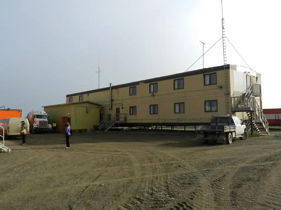 An open-air restaurant is located in an outdoor dirt area.