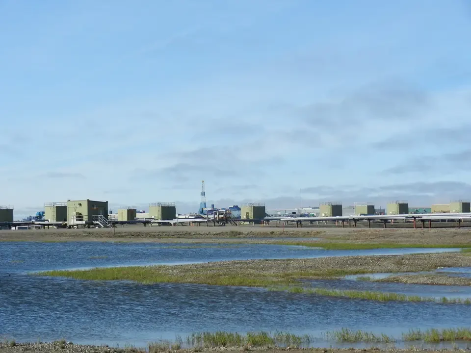 Industrial facilities stretch along the water's edge.