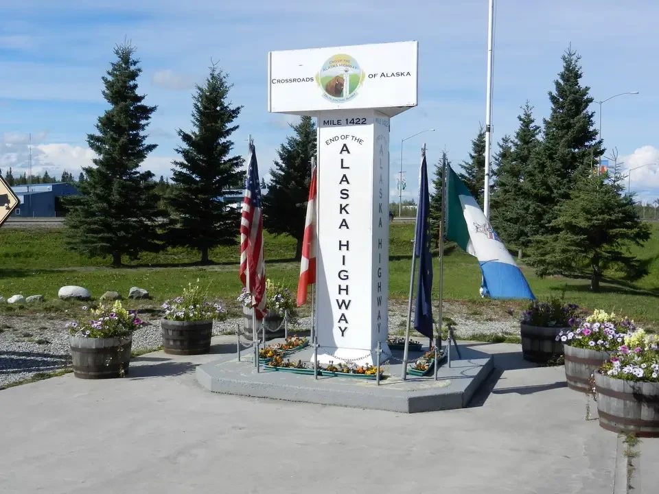 A road sign indicates mile 1422 of the Alaska Highway.