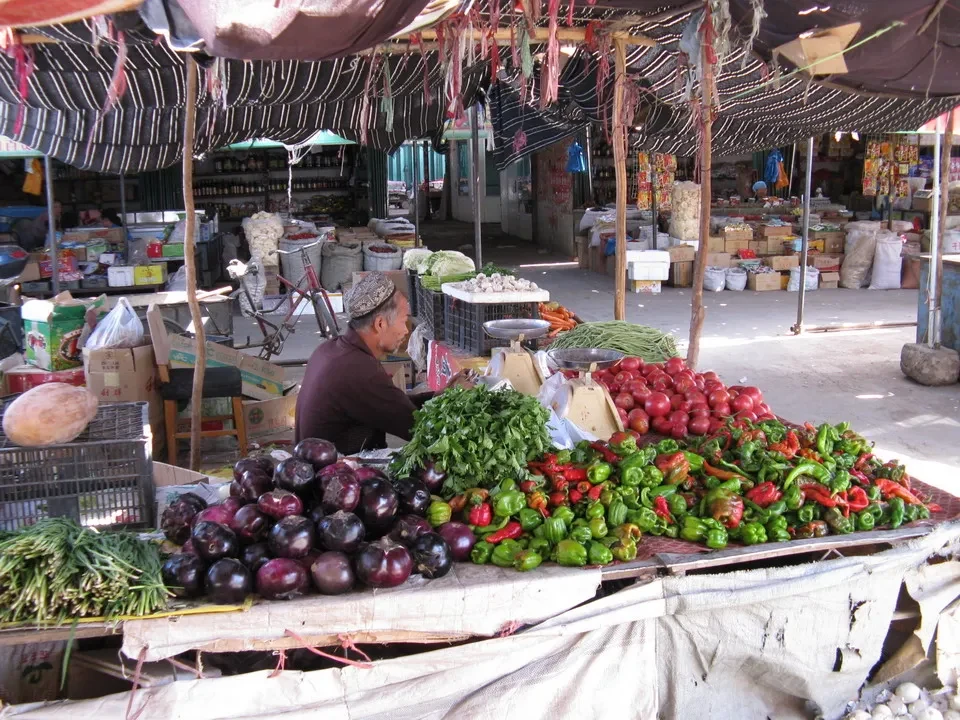 Un mercato all'aperto in Cina mostra una vasta esposizione di frutta e verdura fresca.