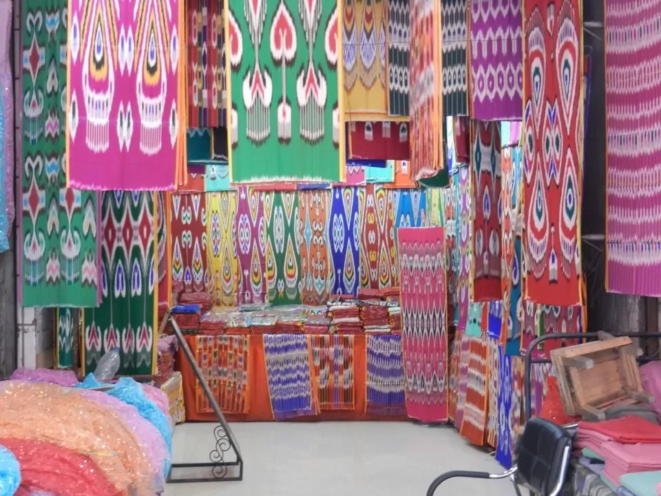 A gallery of colorful carpets is displayed in a Chinese market.