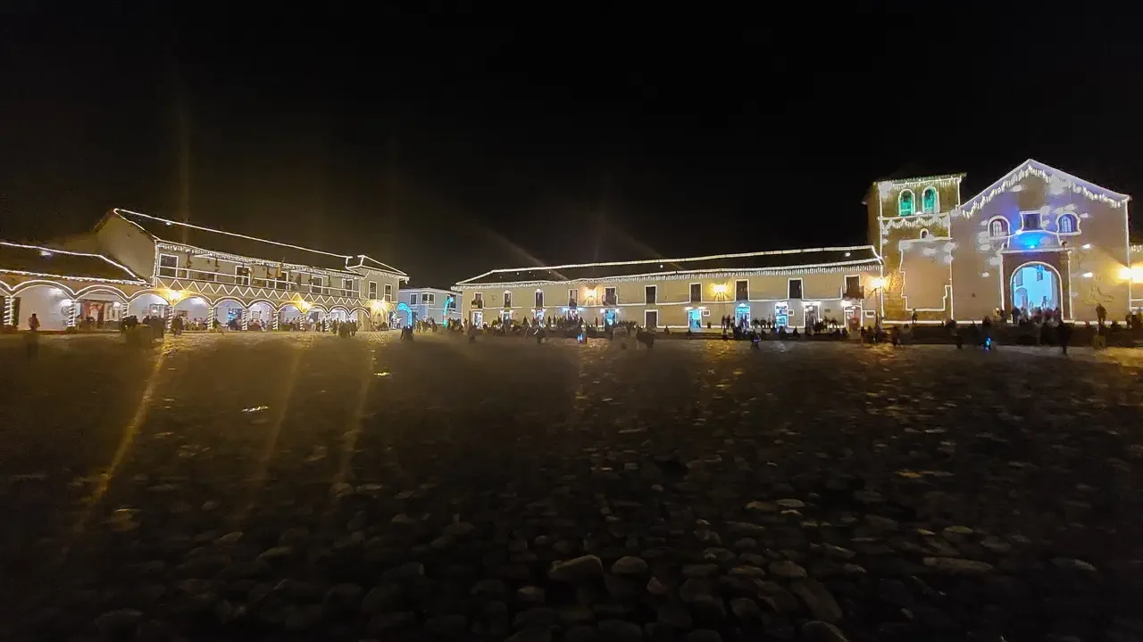 Vista notturna della piazza principale di Villa de Leyva illuminata.