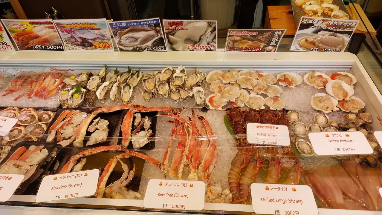 Market of fresh fish and seafood displayed for sale.