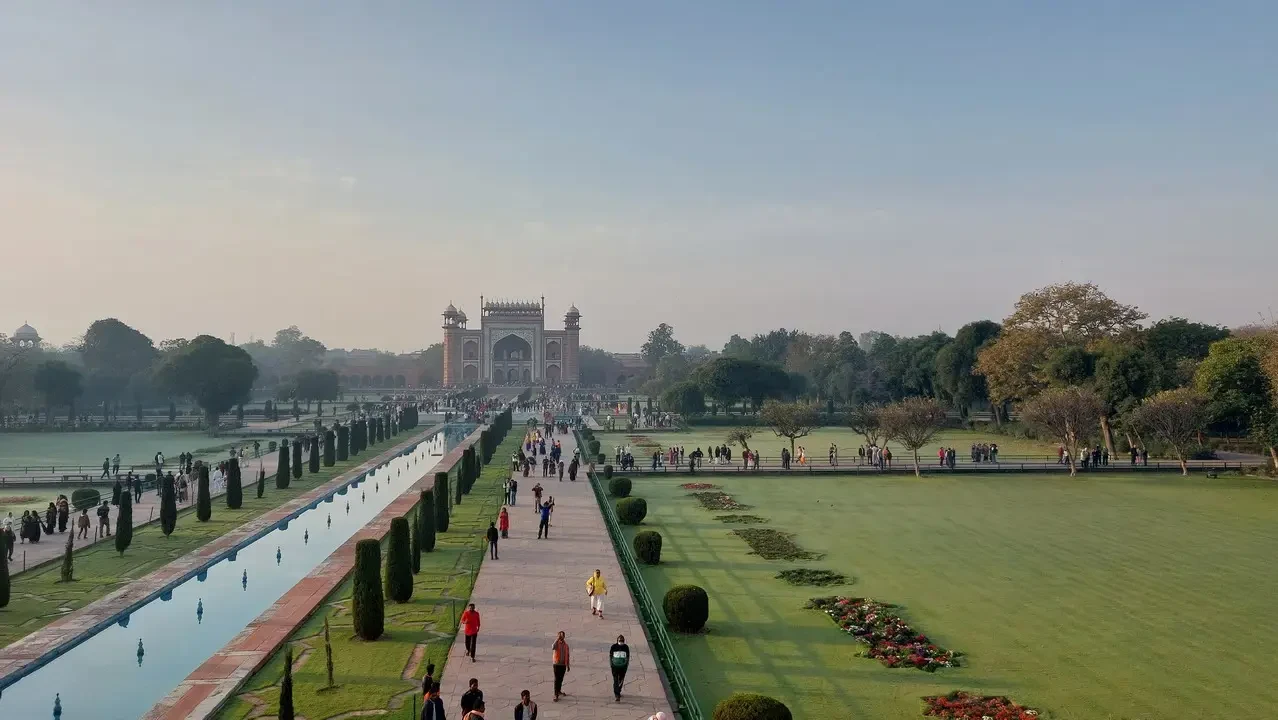 The Taj Mahal is visible with its gardens and surrounding architecture.