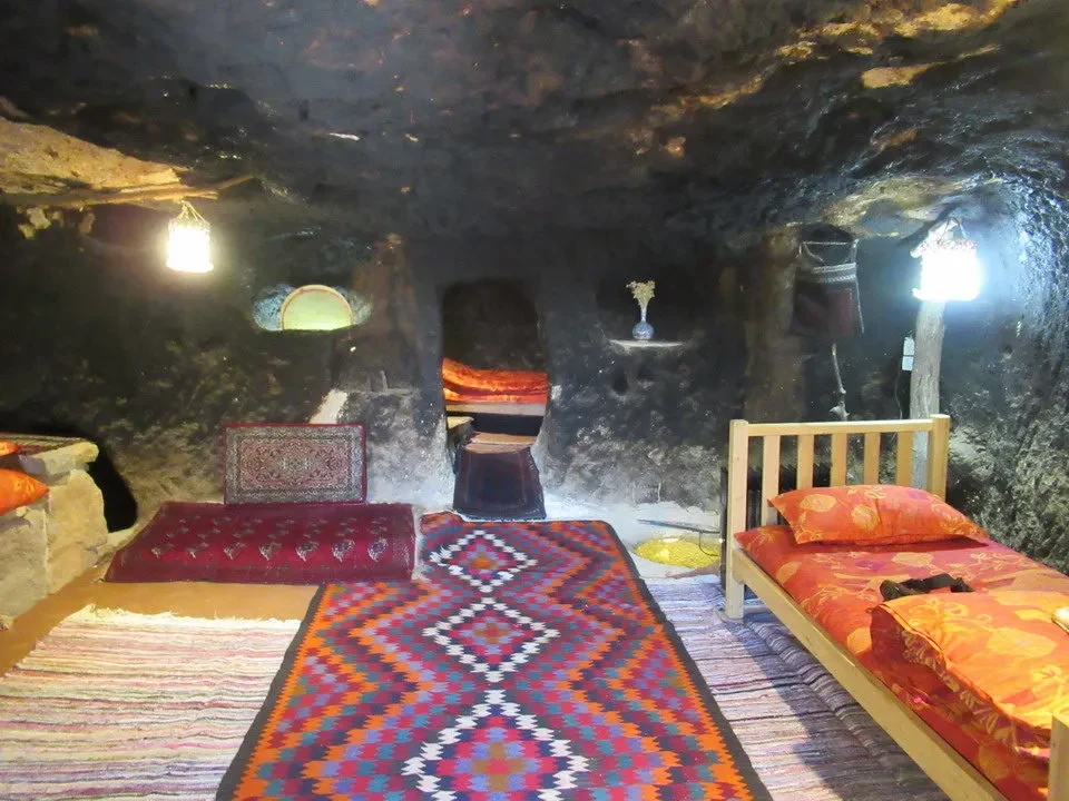 Interno di una grotta con stanze e letti decorati in Iran.