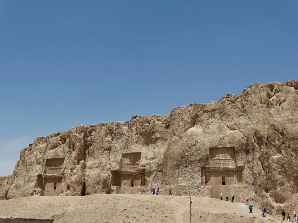 Architettura rupestre di Naqsh-e-Rostam in Iran sotto il cielo azzurro.