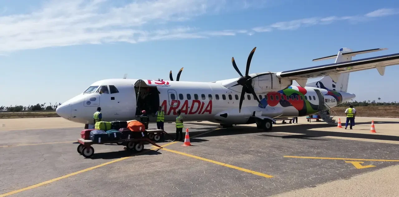 A small propeller airplane is parked on the tarmac at an airport in Madagascar.
