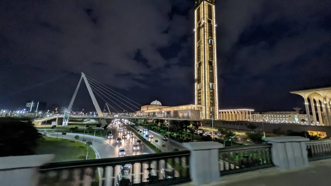 Vista notturna di Algiers con un ponte e un grattacielo illuminati.