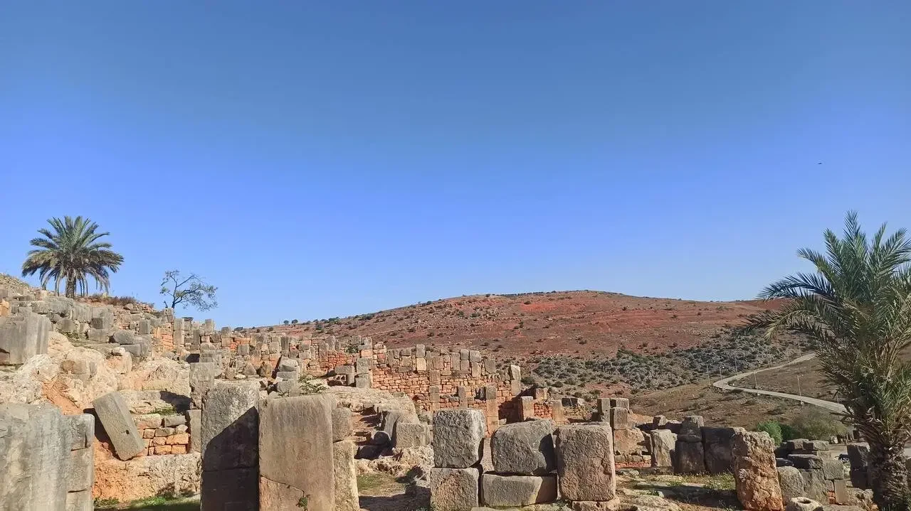 Roman ruins visible on a hill in Algeria.