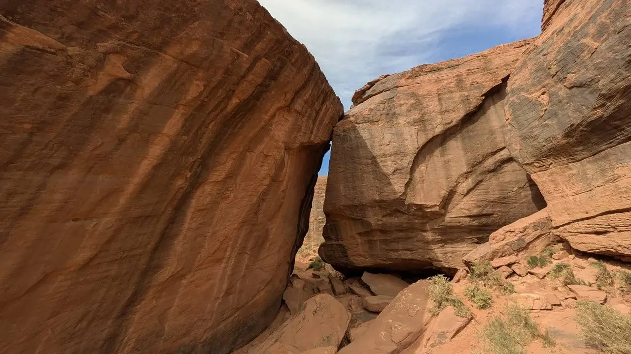 Formazioni rocciose imponenti si ergono in un paesaggio desertico al tramonto.