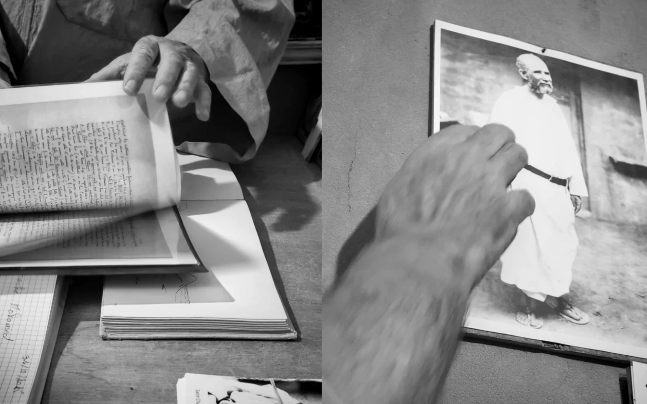 Una galleria fotografica mostra documenti e una fotografia in bianco e nero di un uomo in abiti bianchi.