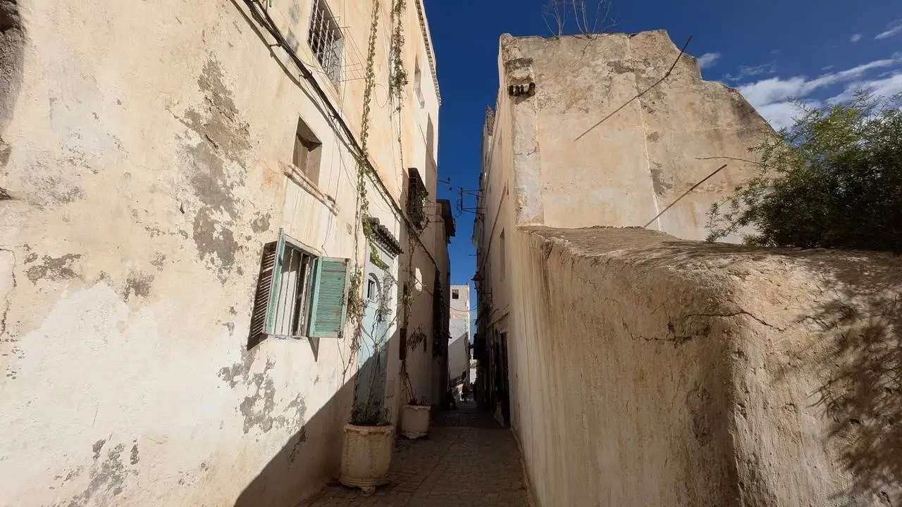 Una stretta via interna nella Casbah di Algeri con pareti chiare e ombreggiature.