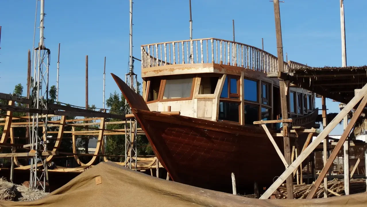 Dhows in the construction yard under the Omani sky.