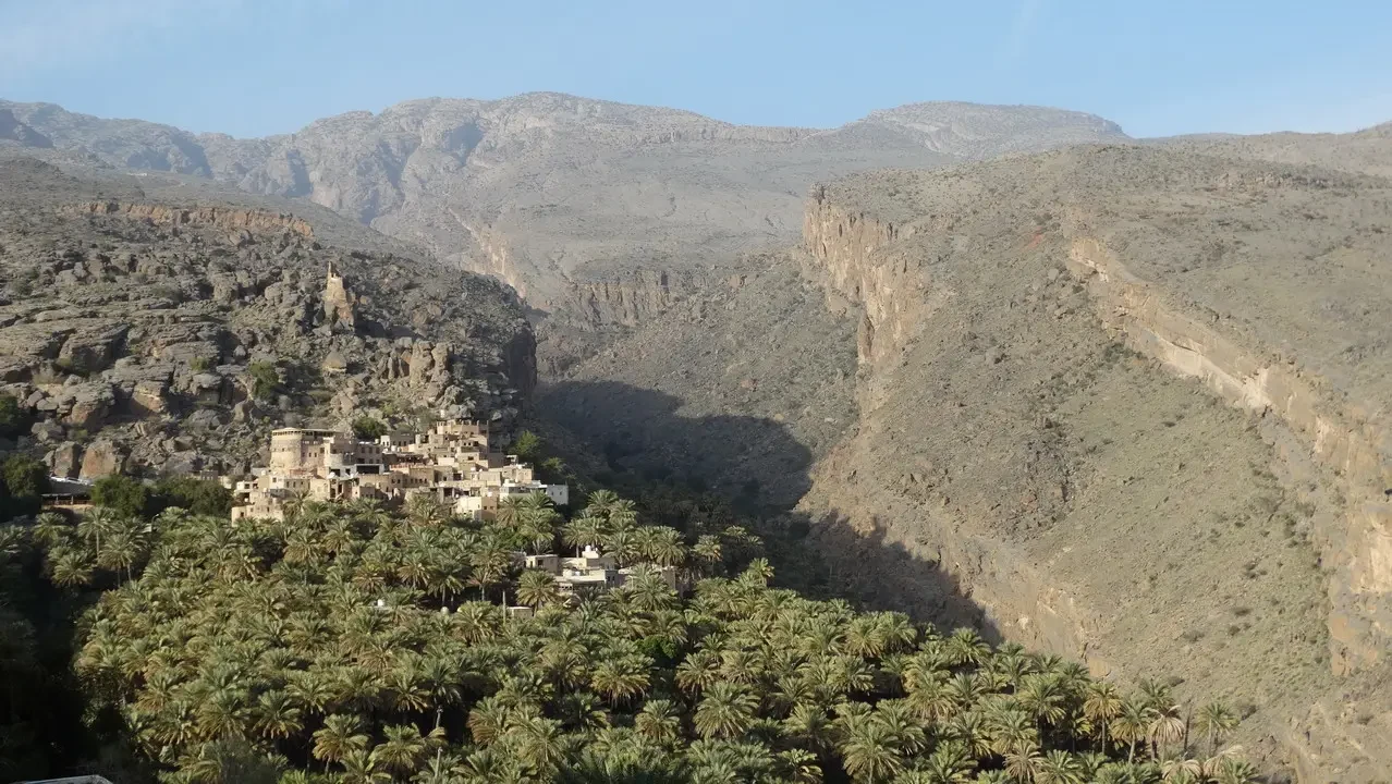 Paesaggio montuoso con insediamenti in una gola arida.
