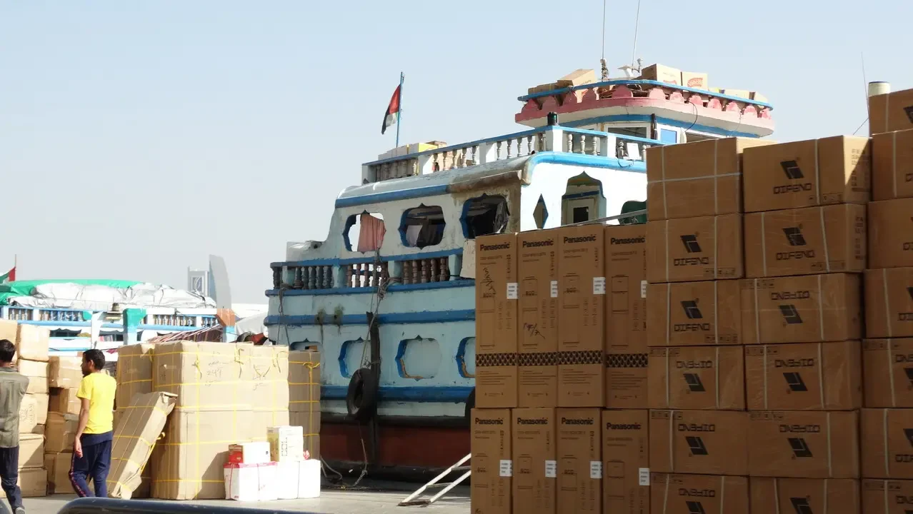 Dhows are moored at the wharf in Dubai, showcasing maritime activity.