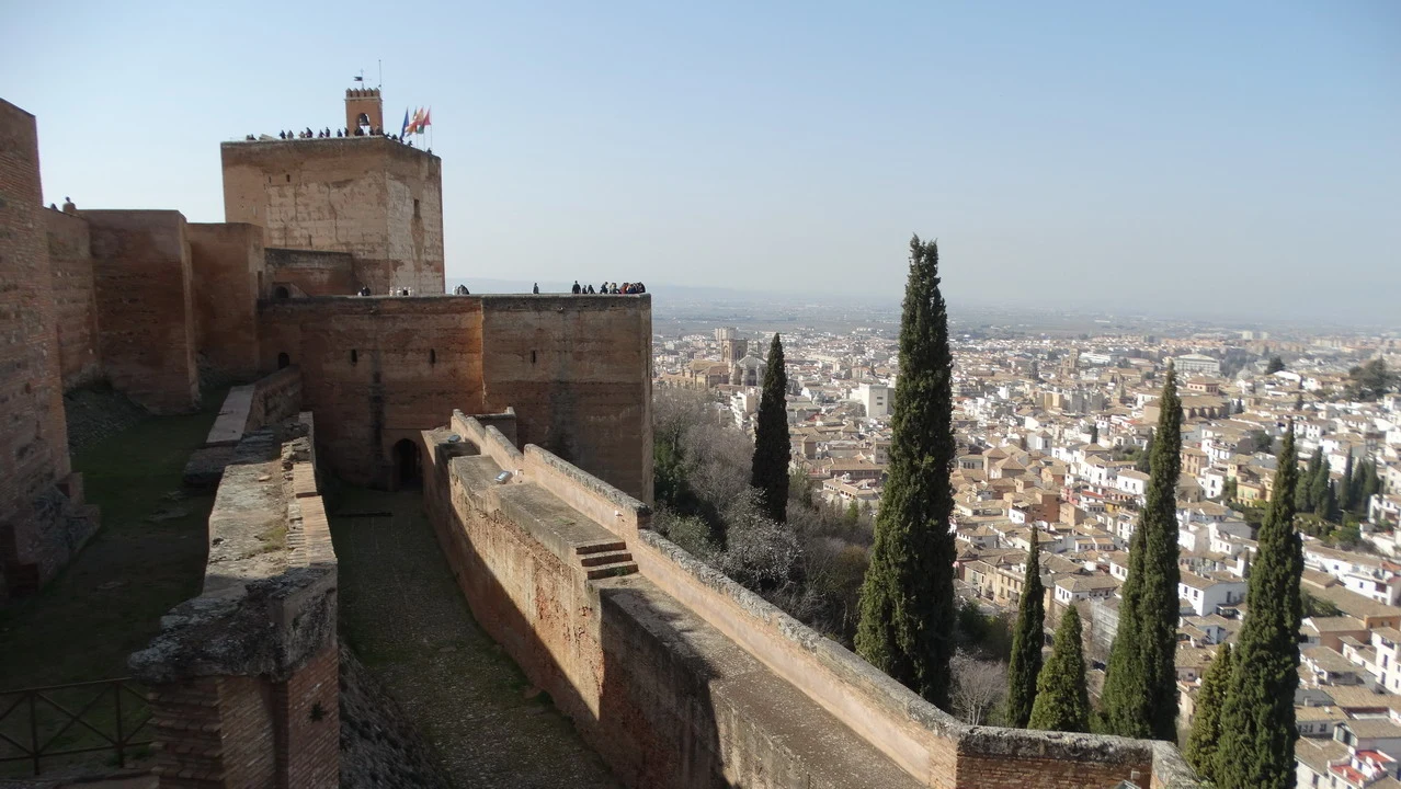 Vista panoramica di Granada con l'Alhambra in primo piano e il paesaggio circostante.