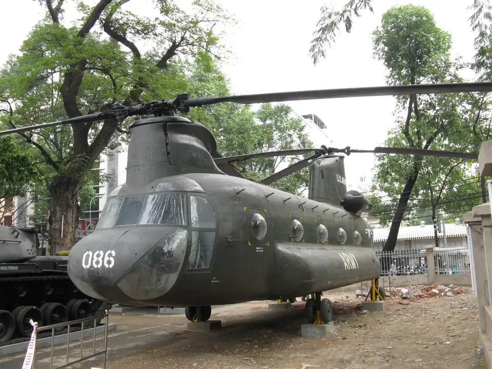 A historical military aircraft is displayed outdoors in a park setting.