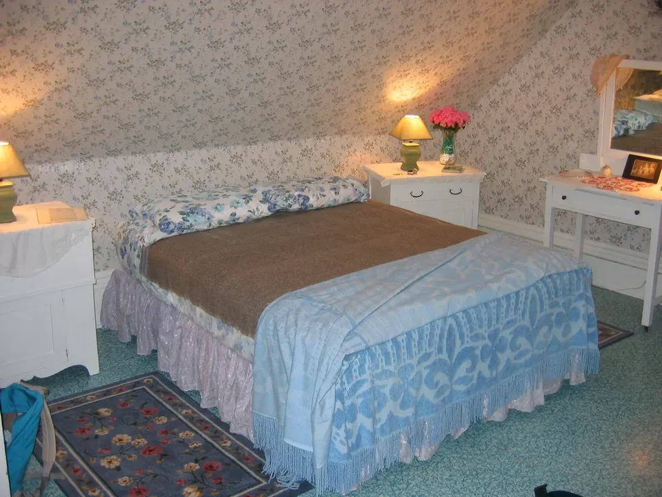 Interno di una stanza decorata con un letto e mobili in stile classico.