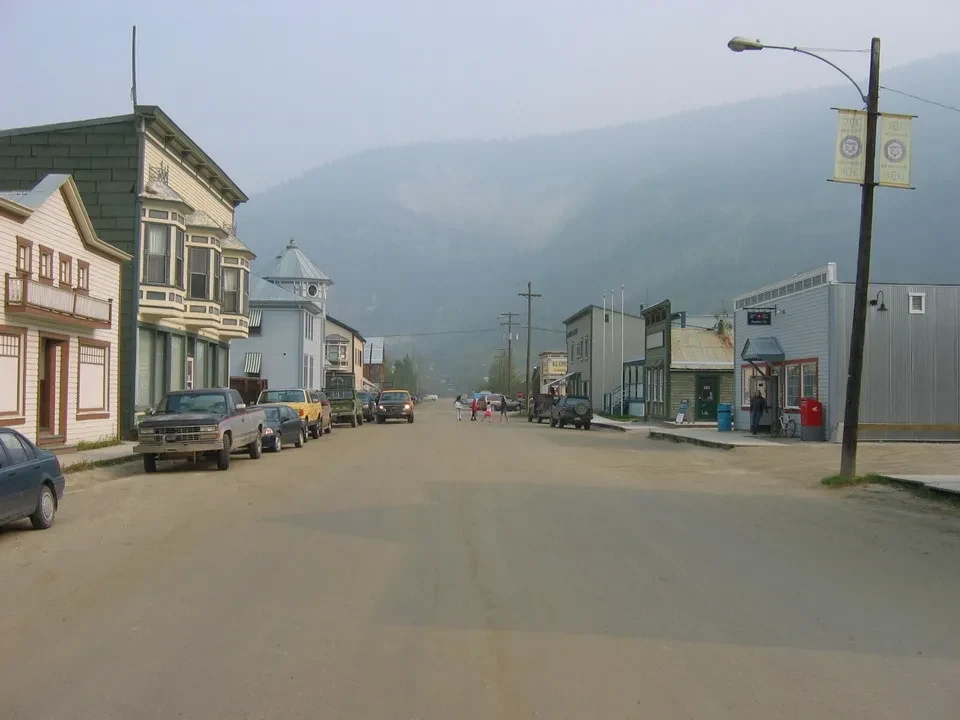 A road leads through a small mountain town in Western Canada.