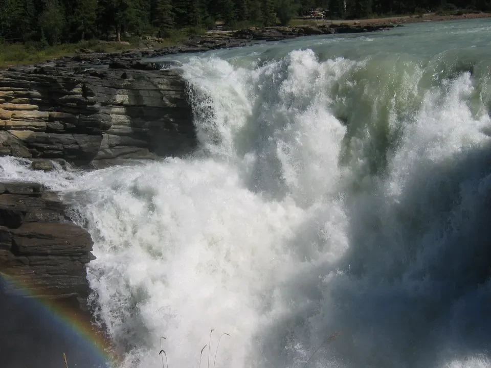 Cascata imponente con arcobaleno sulla roccia in Canada occidentale.